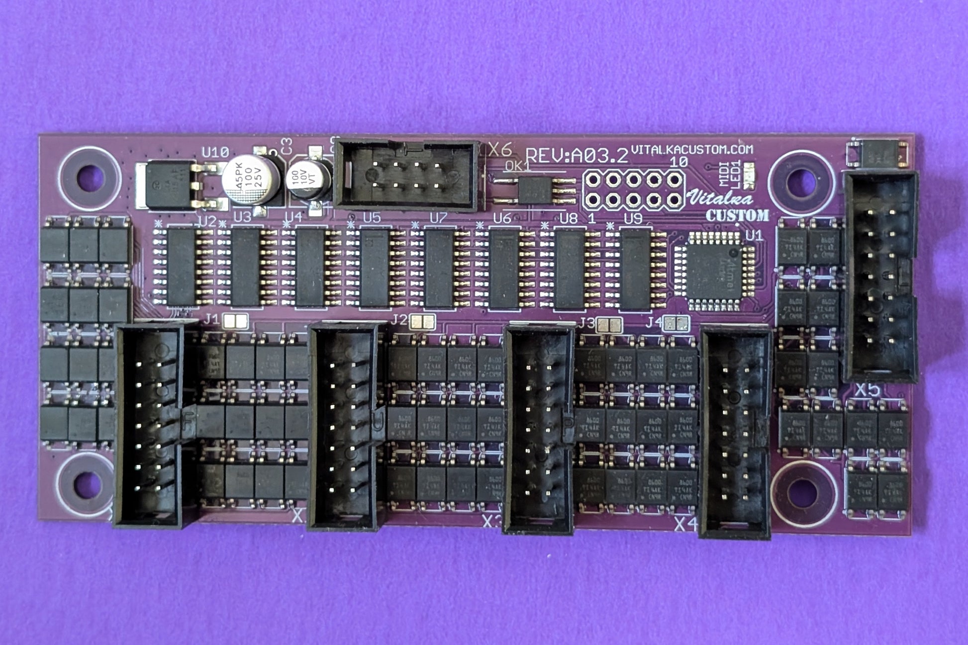 Electronic circuit board on a purple background
